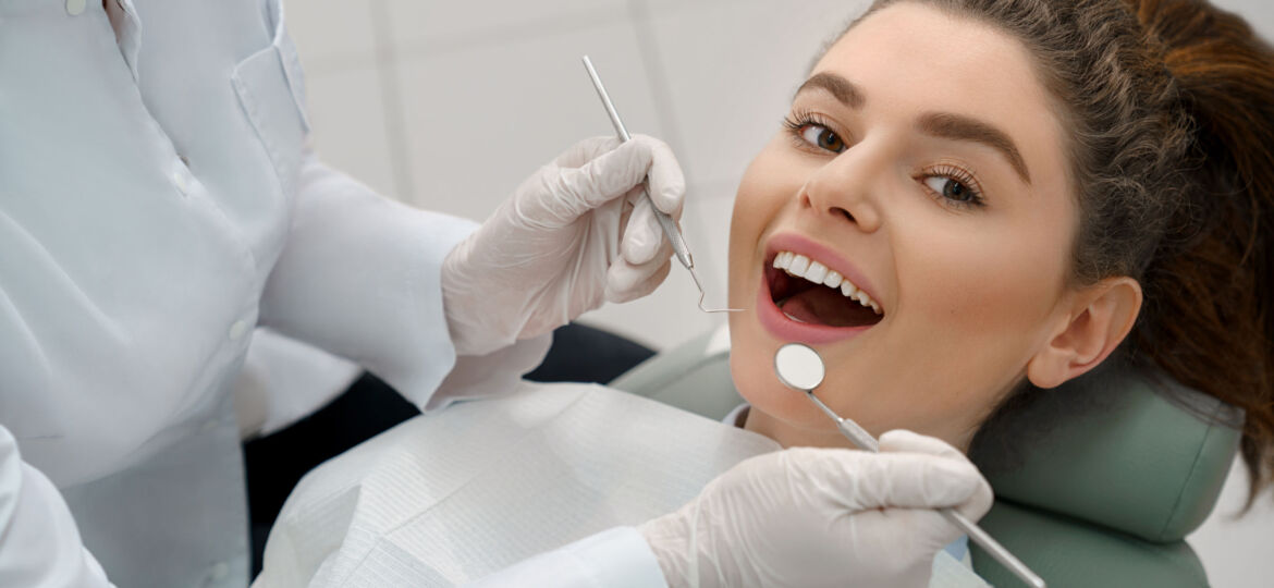 Happy woman lying in dentist chair, posing.