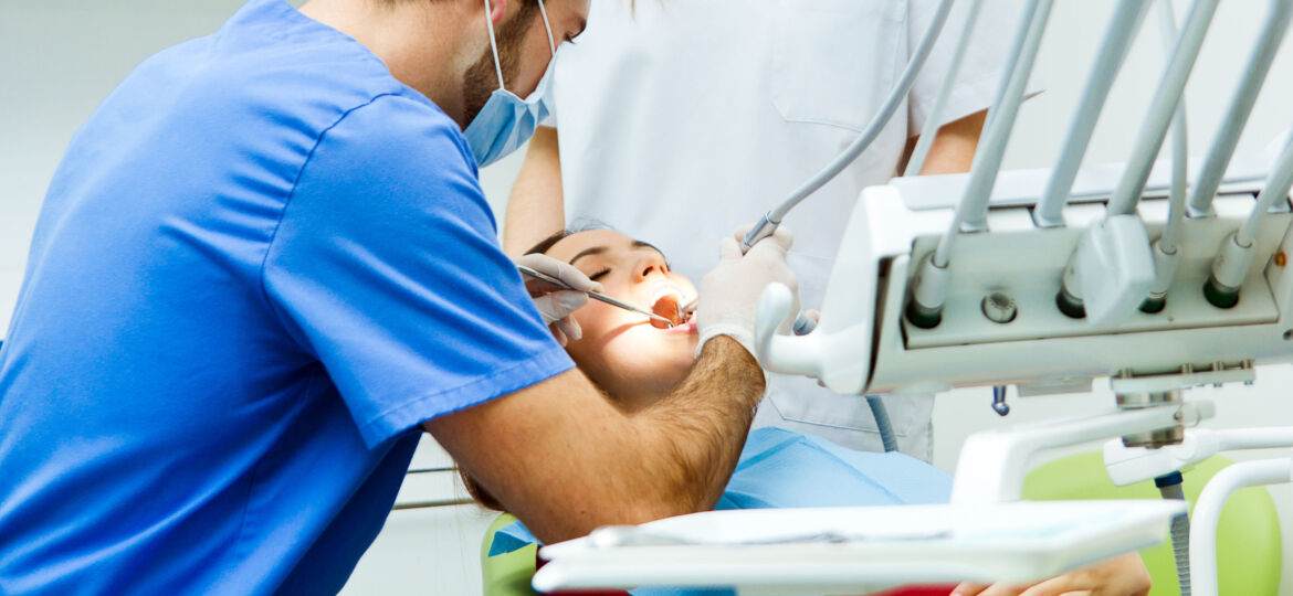 Cute young woman at the dentist. Mouth checkup
